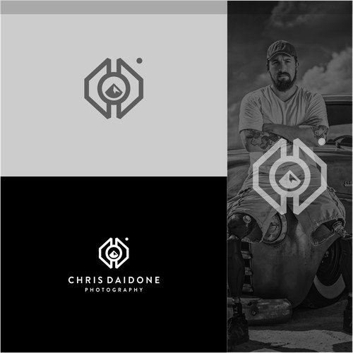 this concept combines several elements namely -using two letters C + D like forming a hexagon (bolt) that has an automotive meaning -and there's a camera lens with a center hole forming a mountain peak